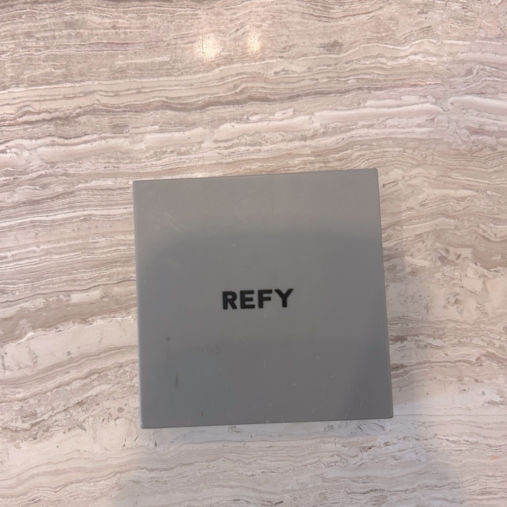 REFY tan crème bronzer. Scraped with a utensil to test and not my color.
